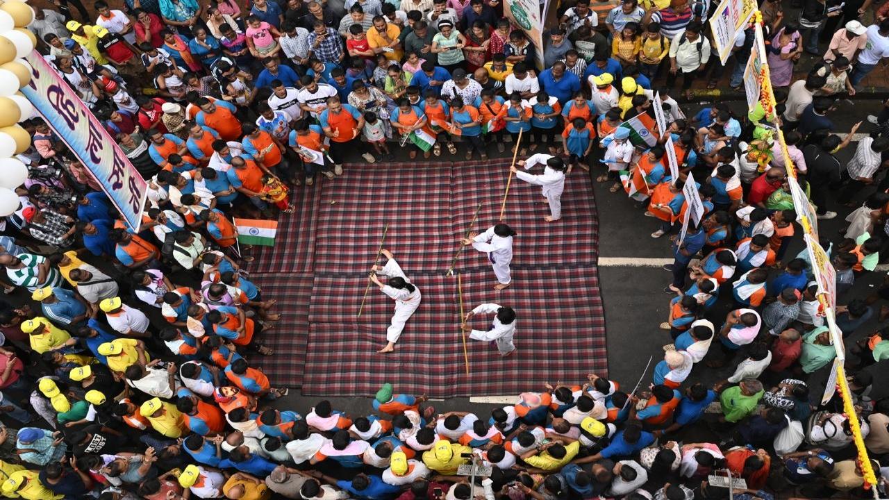 Children perform martial arts at a Dahi Handi event in Dadar on Tuesday