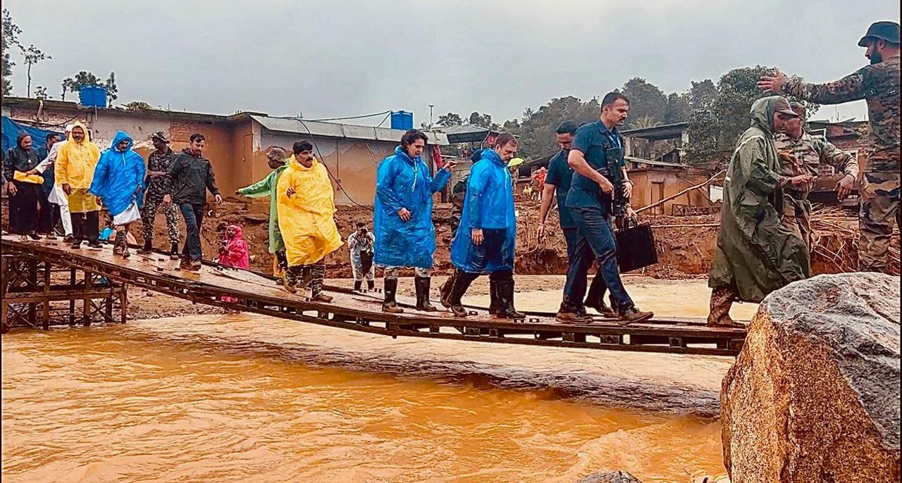 After reaching Chooralmala, Gandhi and his sister -- donning translucent blue raincoats -- crossed the temporary wooden walkway built there, witnessed the construction of the Bailey bridge and walked around the area braving the rain and muddy terrain