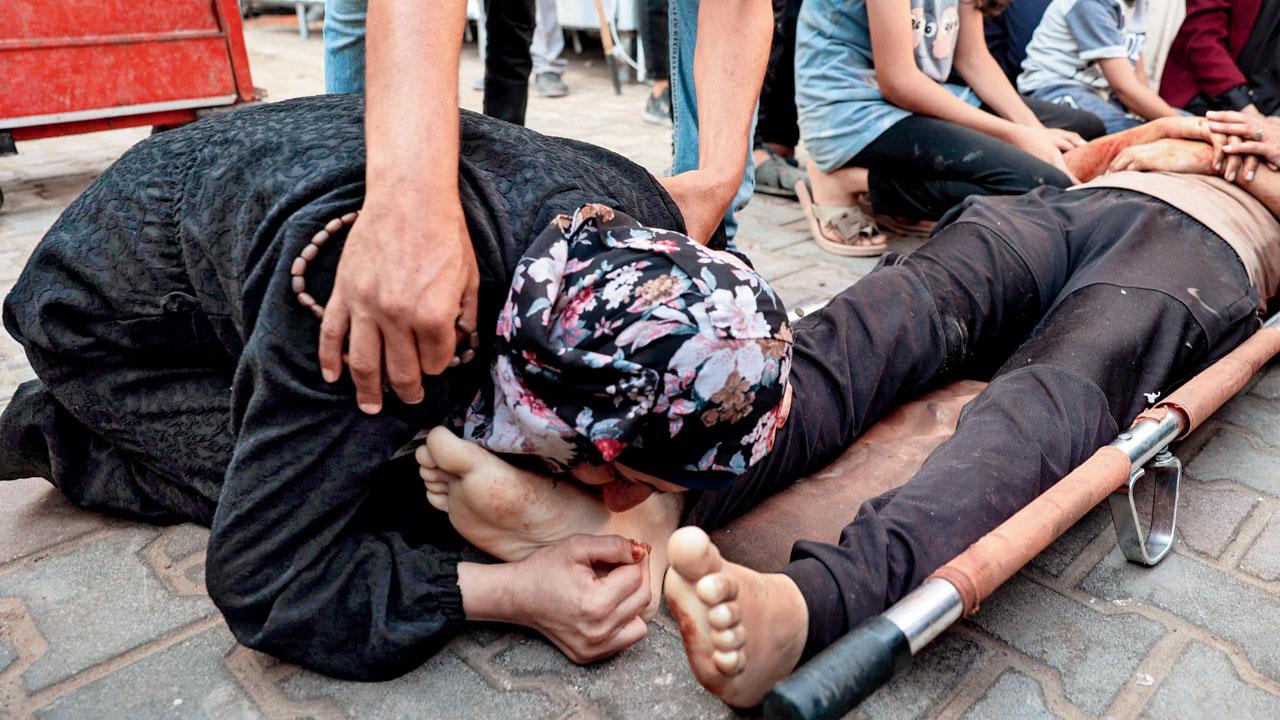 Palestinians mourn over the dead in the yard of the Al-Aqsa Martyrs Hospital in Deir el-Balah in the central Gaza Strip. PIC/PTI