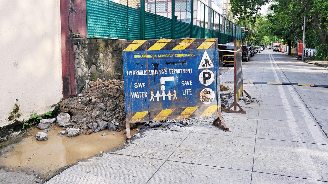The concrete road near D’Monte Park in Bandra West is dug up on Thursday to locate the source of the contamination. Pics/Atul Kamble