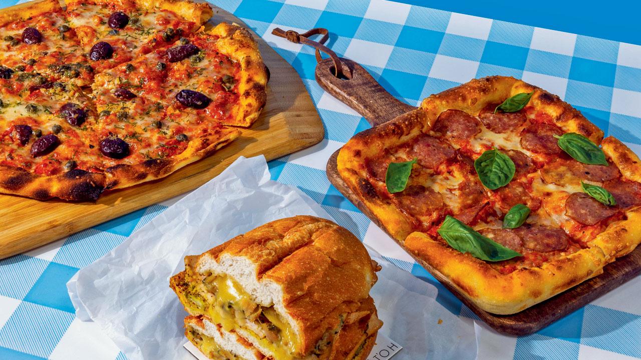 The menu features popular choices like (clockwise from left) puttanesca pizza, pork pepperoni square pizza and chicken Cubano sandwich