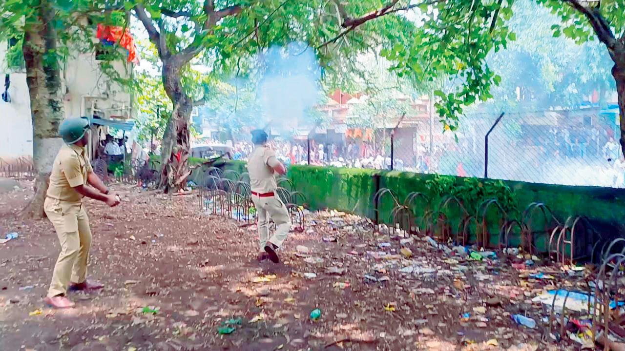 Police personnel firing tear gas outside the school