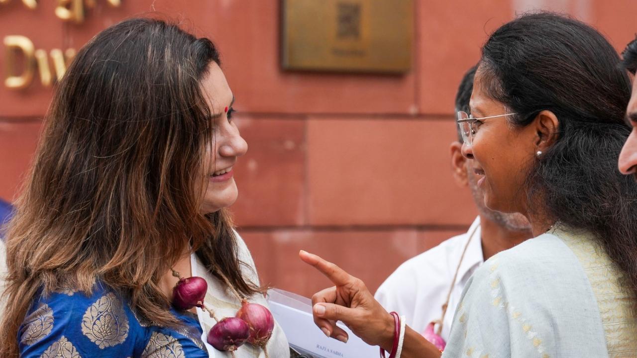 Shiv Sena (UBT) MP Priyanka Chaturvedi greets NCP (Sharadchandra Pawar) parliamentarian Supriya Sule outside the Parliament during the protest on Thursday 