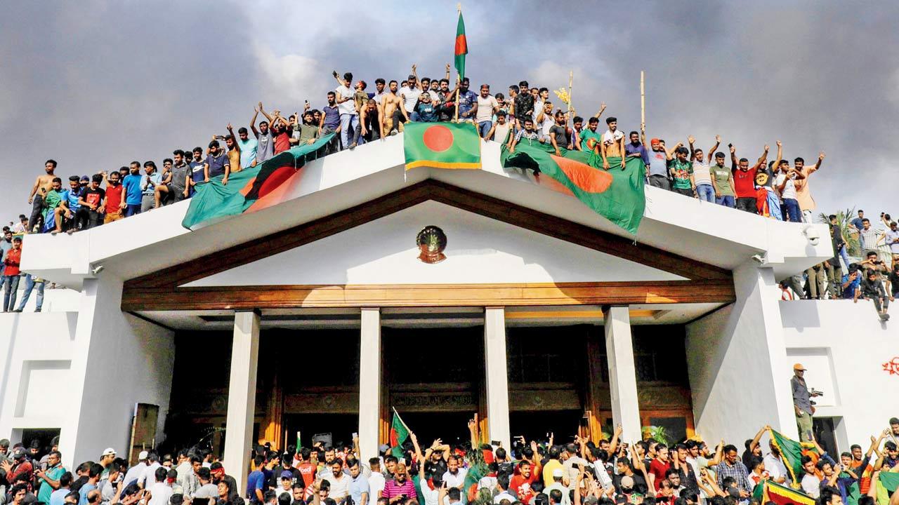 Protesters storm Hasina’s official residence in Dhaka, on Monday. Pics/PTI