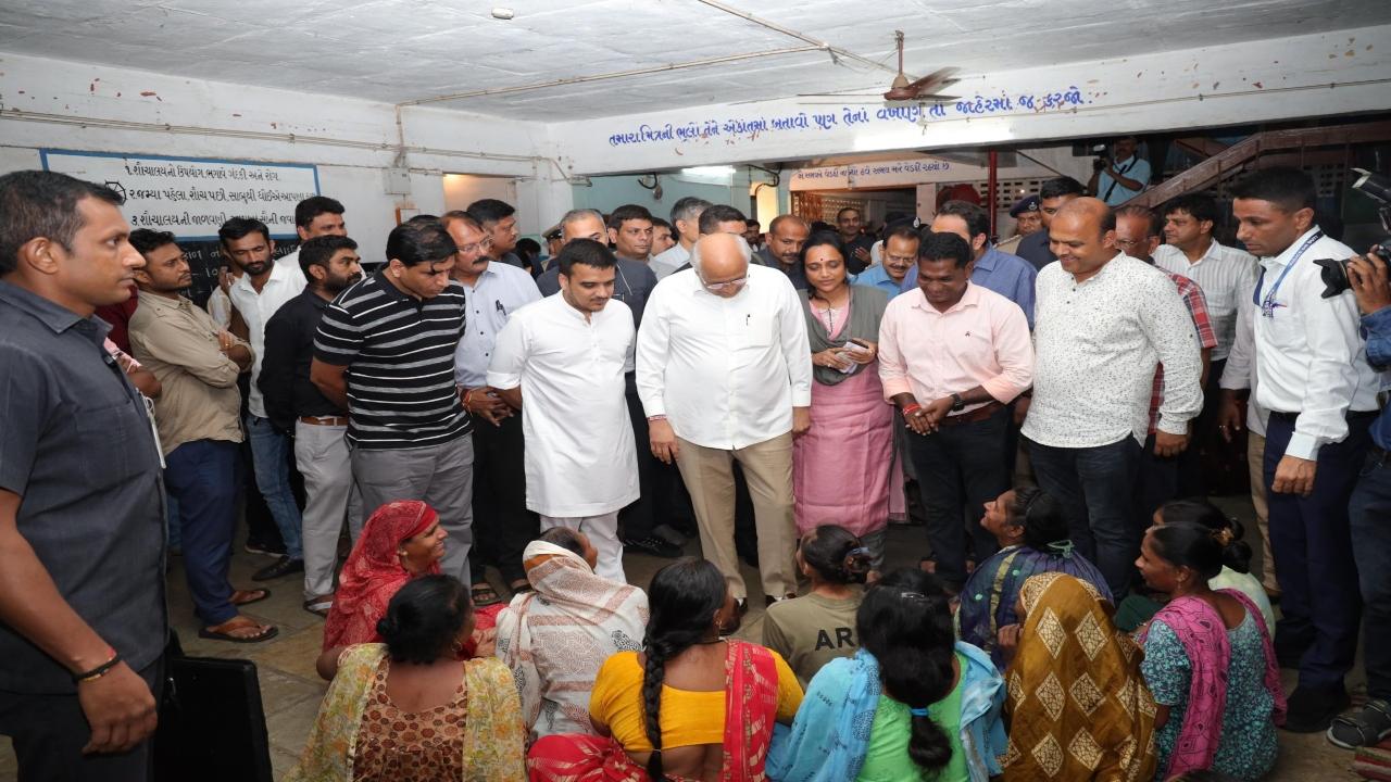 CM Bhupendra Patel meets flood-affected residents of Fatehpura in a school which is being used as a relief camp