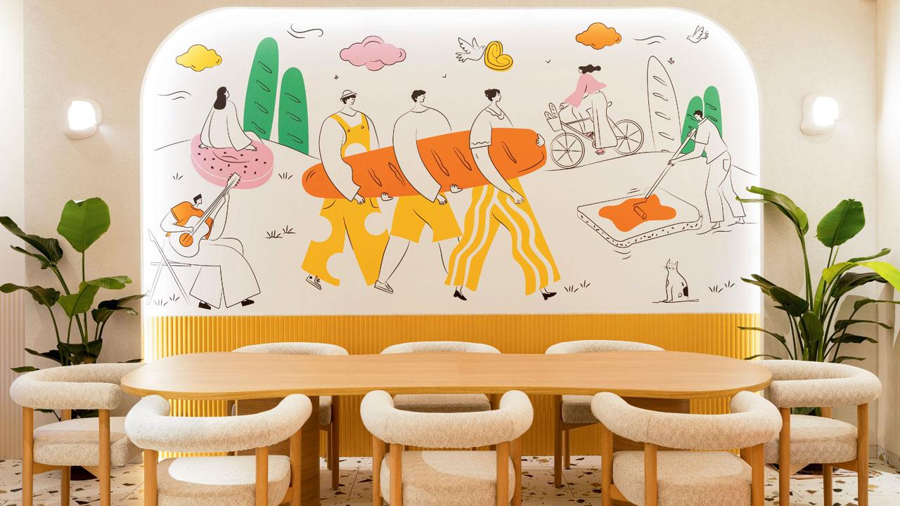 The mural of bread makers on the wall of the Chembur cafe 