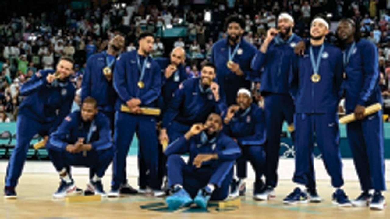 The US basketball team with their gold medals in Paris on Saturday