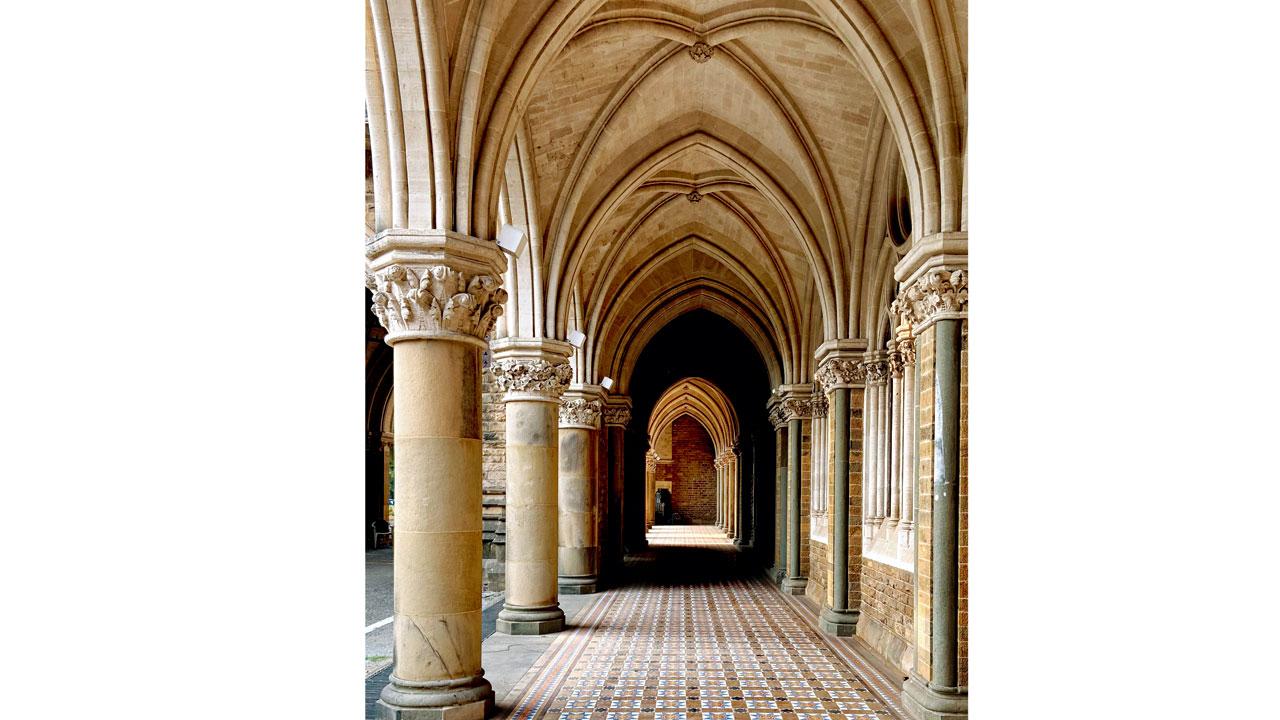 A photograph of the University of Mumbai campus is used as reference to create