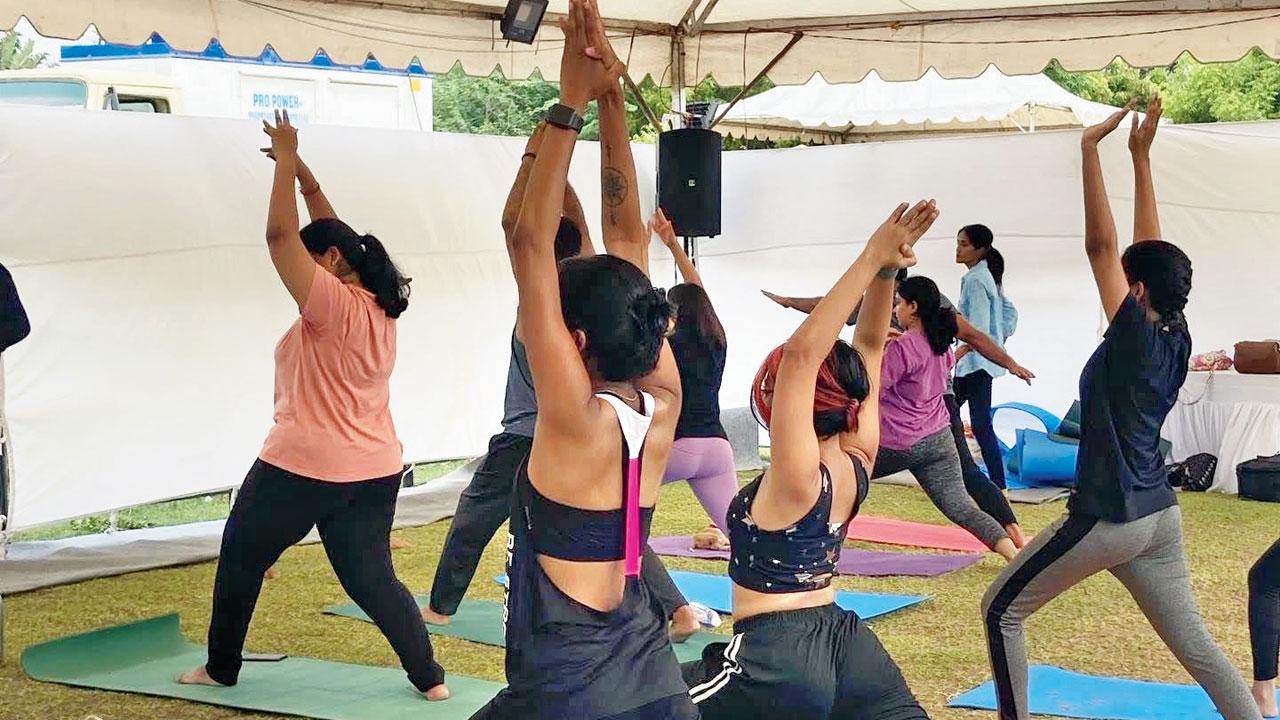 Women practise yoga alongside puppies at a previous session
