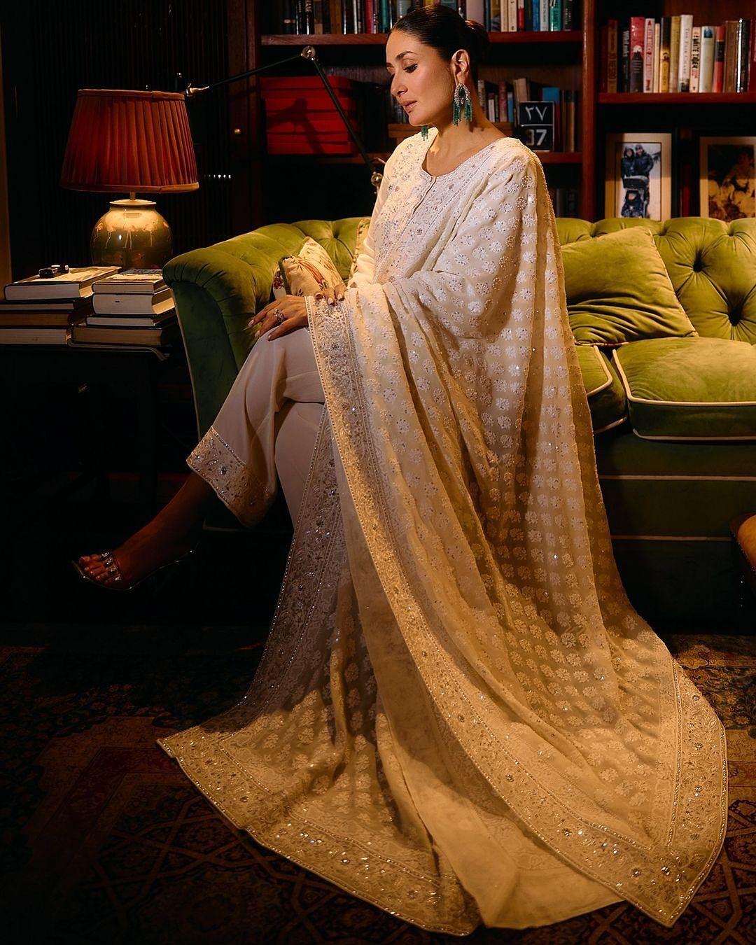 The outfit is accented with shimmering sequins, pearls, and stones.