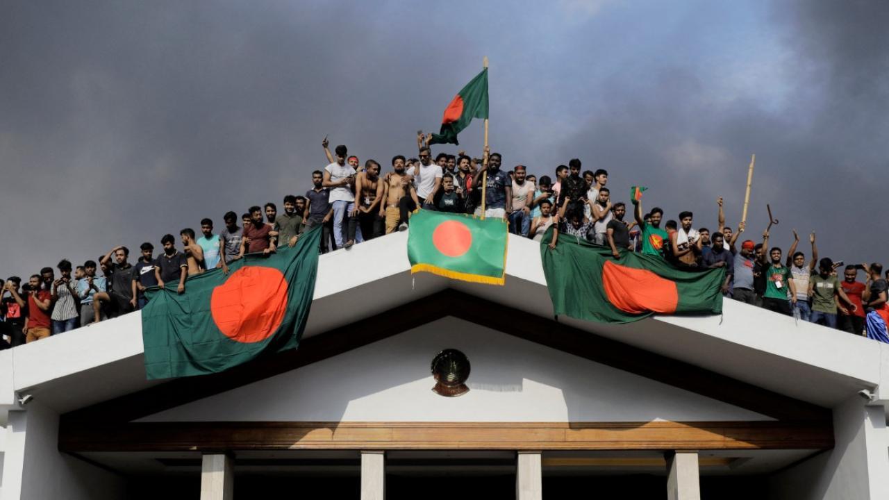 The end of Sheikh Hasina's 15-year-rule turned into a celebration, as students waved flags from the rooftop of her home after she fled the country by helicopter on Monday, Aug 5. Pics/AFP