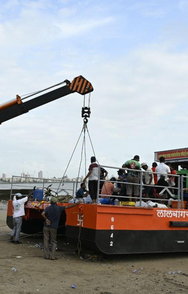 As part of the preparations for the Ganesh immersion festival, BMC workers are erecting pandals at Girgaum Chowpatty.