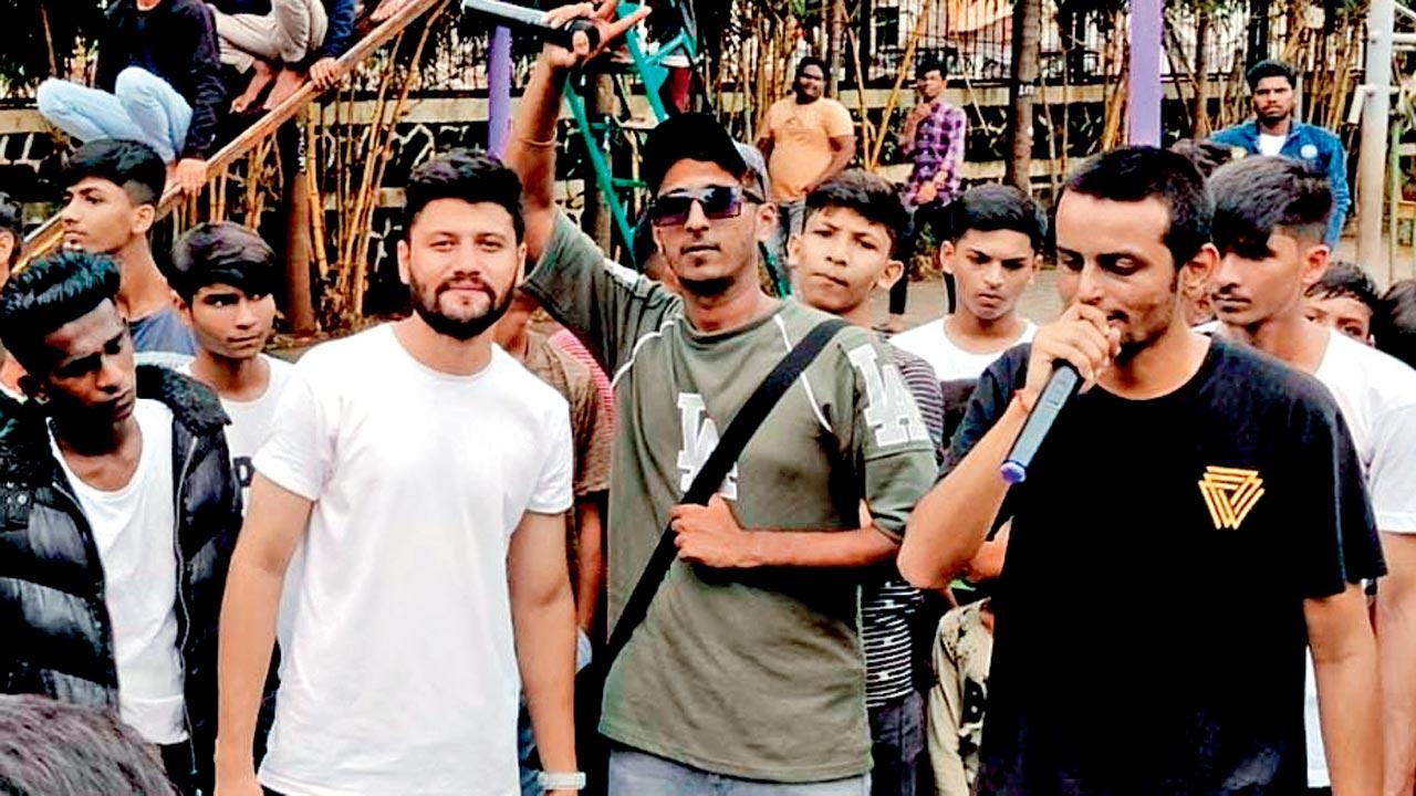 Shafi Shaikh (in grey) performs with a crewmate