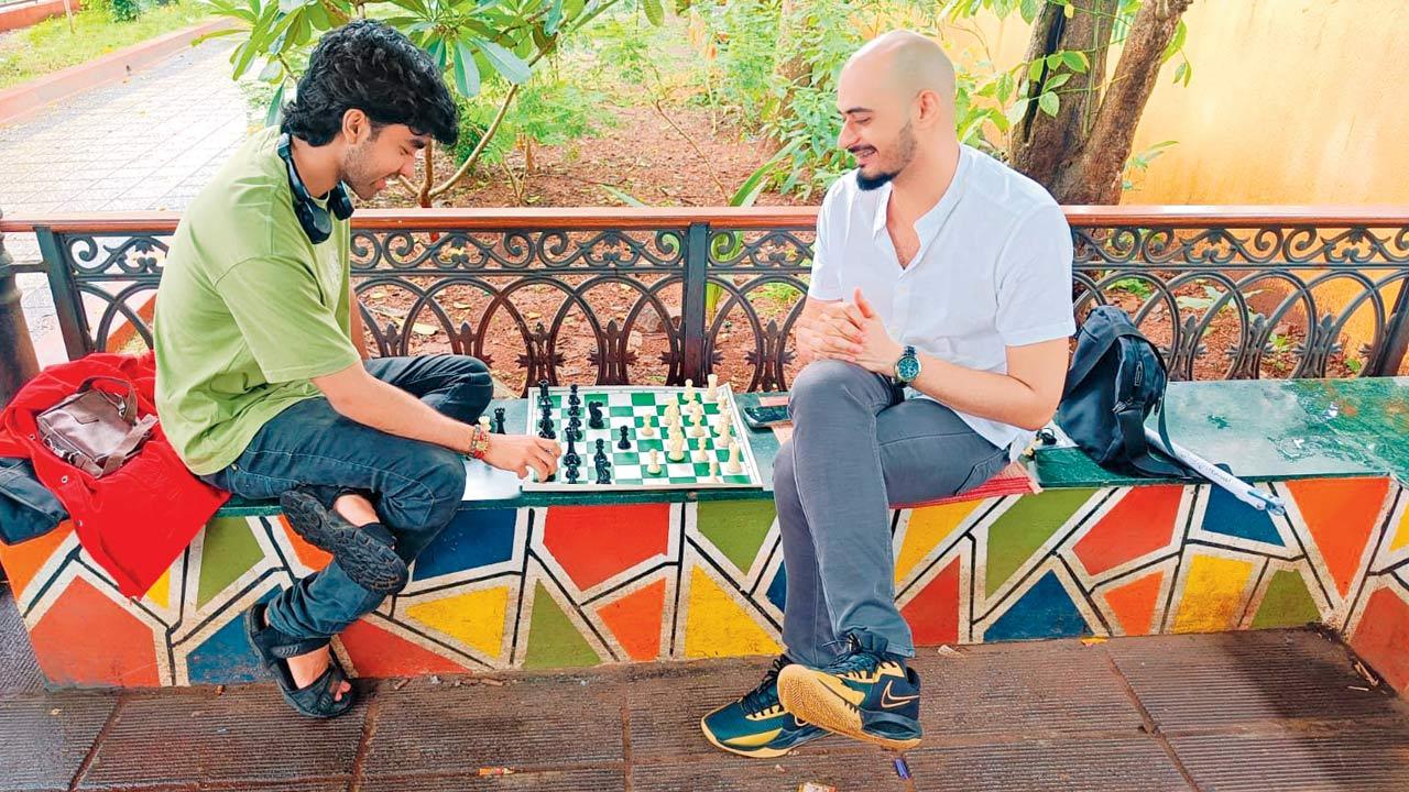 Rangani (left) plays chess with a participant at the venue