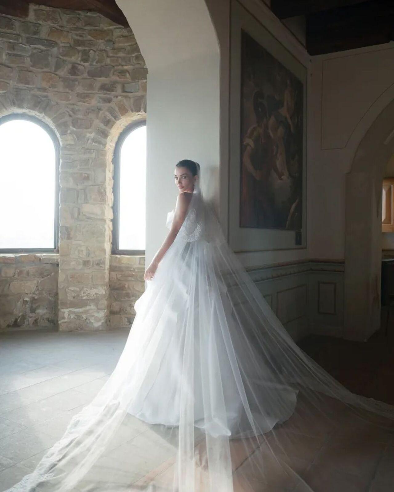 Amy Jackson looked absolutely radiant in a classic white gown that featured an ethereal veil cascading elegantly to the floor.