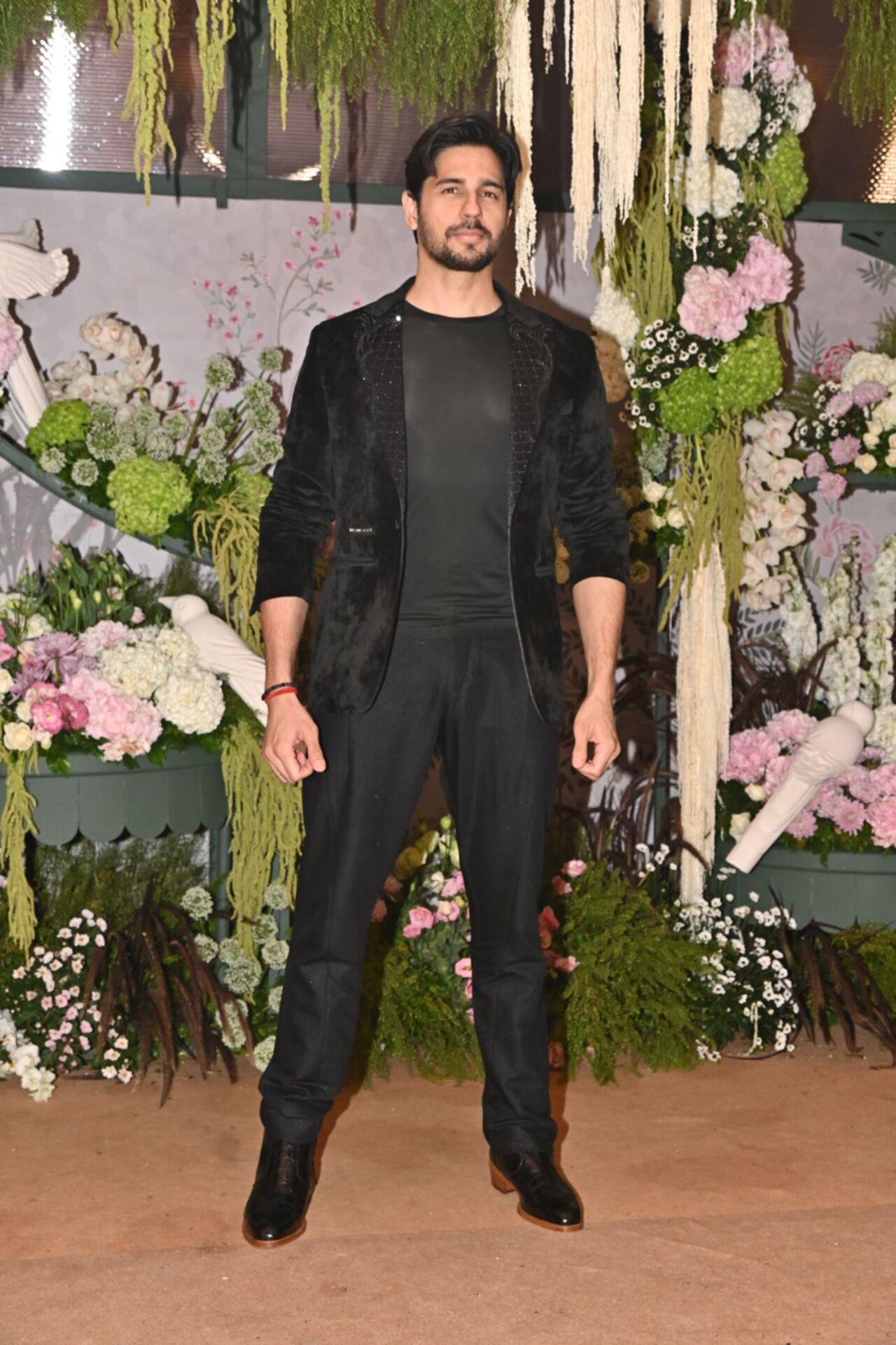 Sidharth Malhotra made a dashing appearance in a classic black suit, embodying modern elegance.