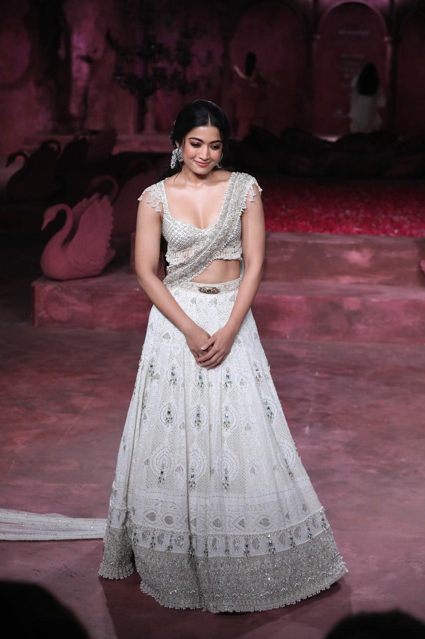 Rashmika Mandanna opened the show in a white and silver lehenga with a princess-like headpiece. 