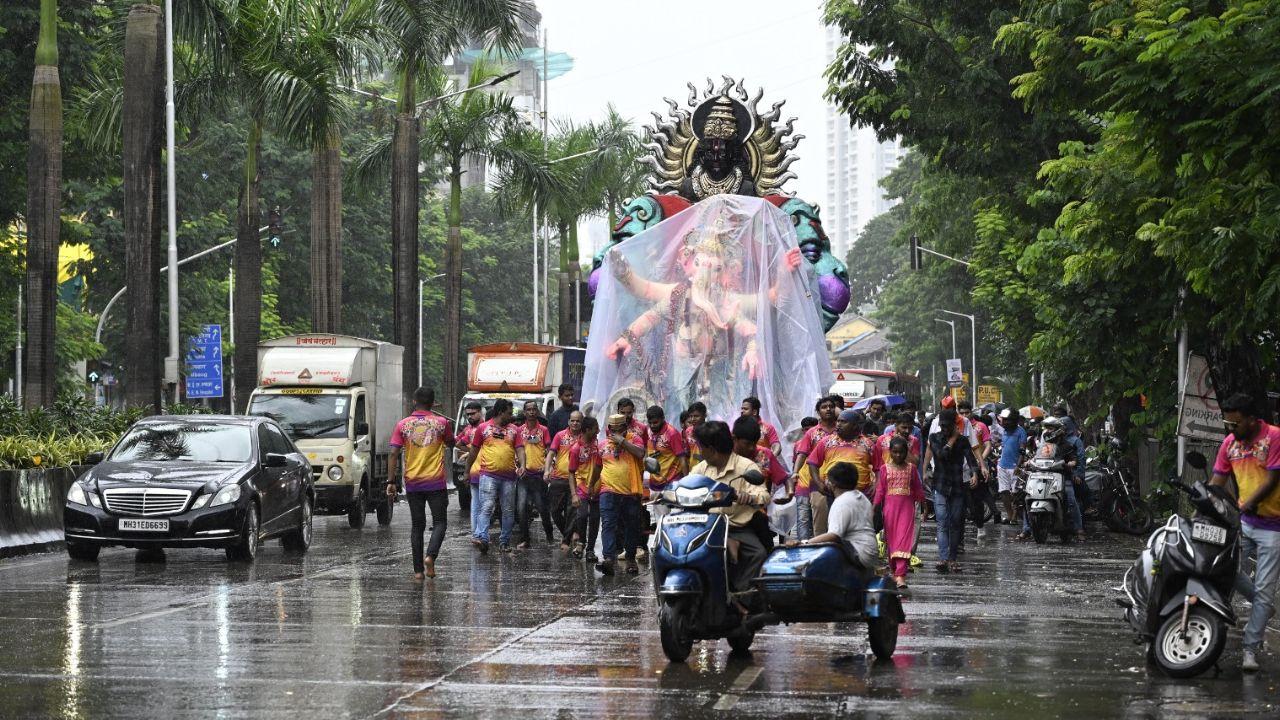 The Parel-Byculla flyover was lined with spectators watching the Kala Chowki Ganesh Idol arrival procession as it passed through Lalbaug. 