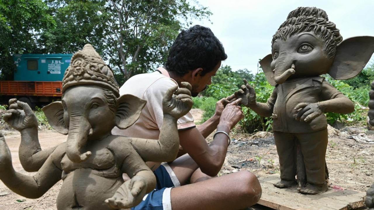 An artisan works on eco-friendly idols of Lord Ganesha made with mud, jute and bamboo to reduce water pollution during the immersion rituals ahead of the Ganesh Chaturthi festival, at a workshop in Hyderabad on August 28, 2024