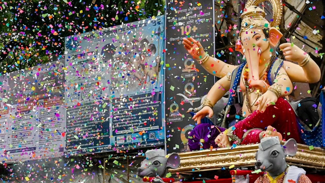 Devotees carry a Ganesha idol during a procession along a street in Mumbai (Pic: AFP)