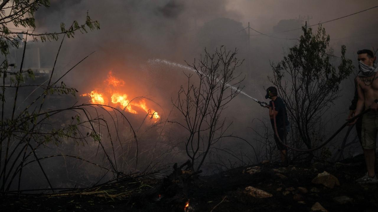 A blanket of smoke and ash shrouded central Athens while power cuts hit parts of the Greek capital and affected traffic lights at major central junctions