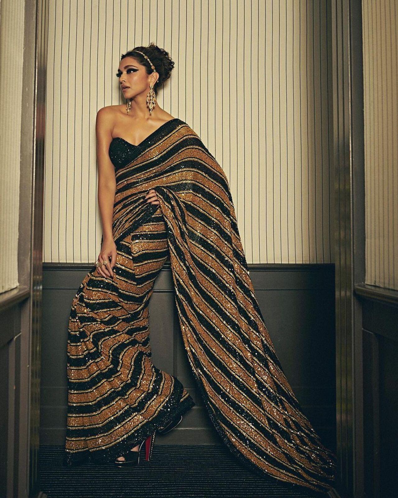 At Cannes, Deepika Padukone, who was a jury member, wore a mustard and black sequin-embellished saree by Sabyasachi. The strapless, sweetheart-neck blouse gave it a modern twist, and the intricate embellishments made it suitable for the red carpet.