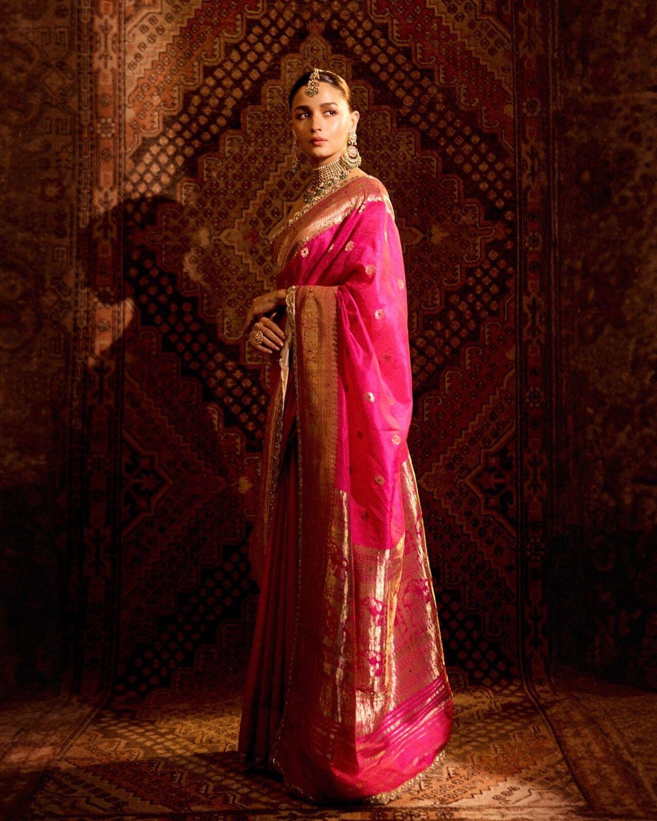 
For Anant and Radhika’s wedding, Alia Bhatt wore an archival saree crafted from pure silk and adorned with real zari—99 percent pure silver and about 6 grams of gold. This beautiful Ashavali weave saree, approximately 160 years old, showcases the rich legacy of artistry and beauty, drawing inspiration from the intricate Baluchari sarees of West Bengal.
 

 