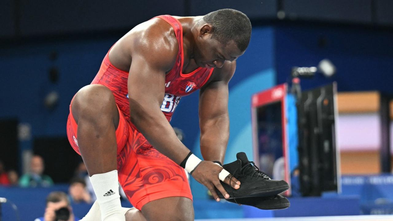 Mijain Lopez
Cuba's wrestler Mijain Lopez after defeating Chile's Yasmani Acosta Fernandez in the finals of the men's Greco-Roman 130kg removed his shoes as a sign of retirement from the sport