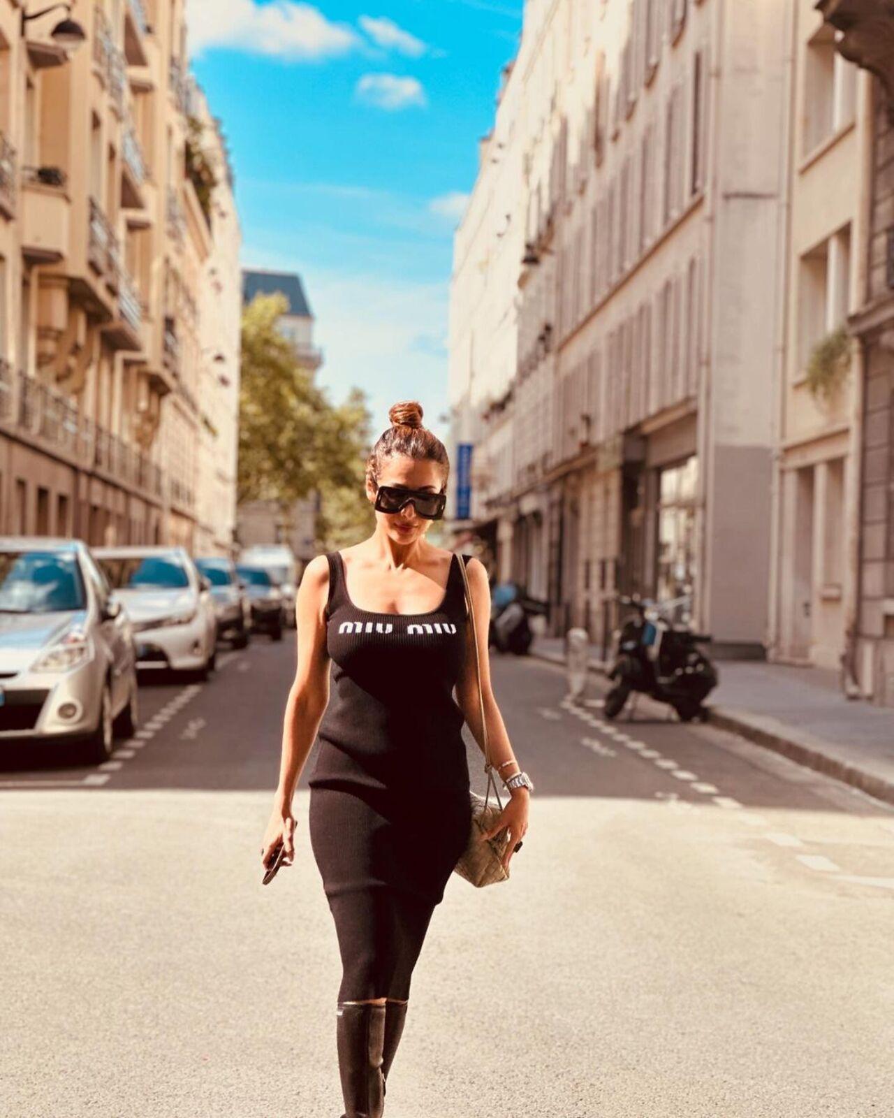 For her stay in Paris, she put on a black bodycon dress and paired it with giant sunglasses. 