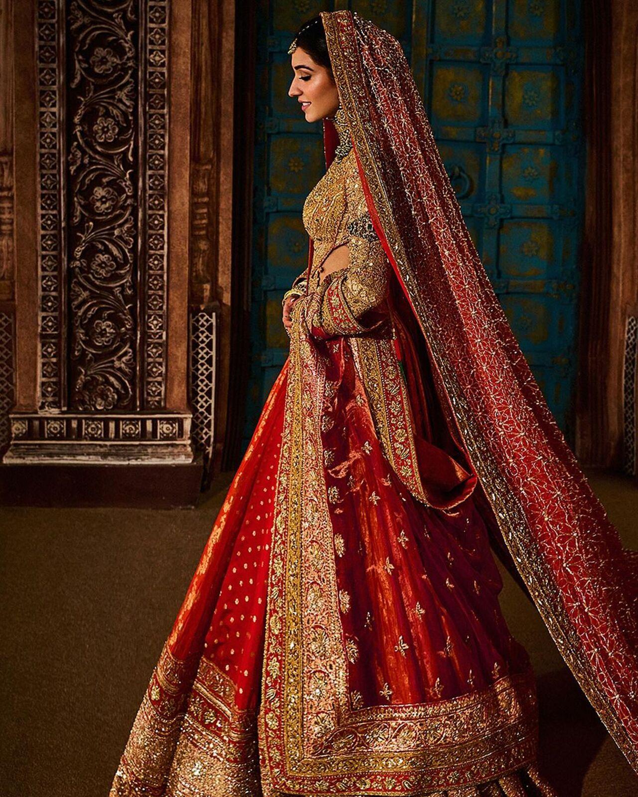 For her Vidai ceremony, Radhika Merchant wore a multi-paneled Banarasi brocade lehenga in sunset hues and an exquisite blouse featuring real gold karchobi work, inspired by the traditional abho and the rich textile heritage of Kutch, Gujarat, echoing the artistry of the late 19th century.