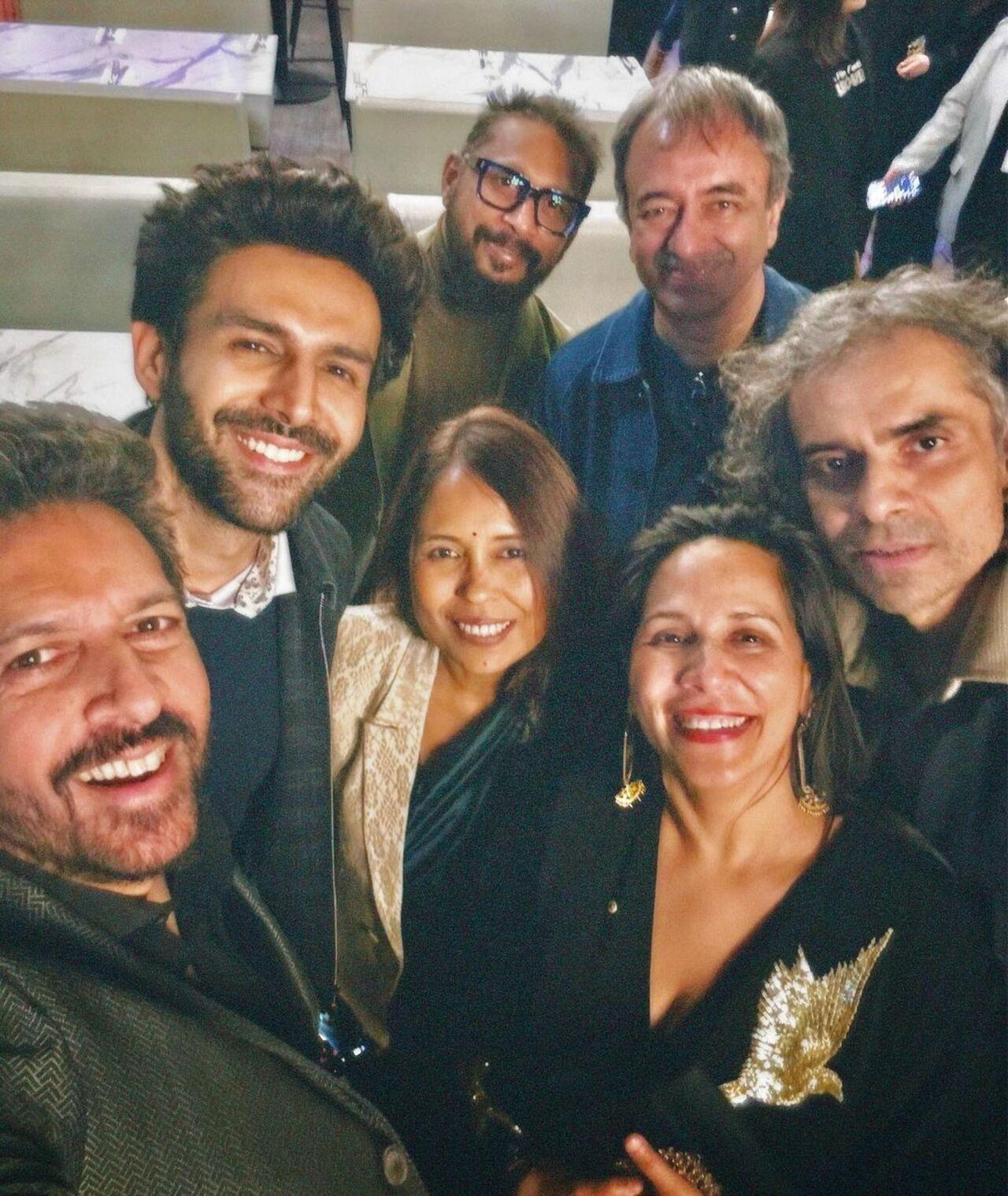 Kartik Aaryan poses for a selfie with filmmakers Kabir Khan, Shoojit Sircar, Rajkumar Hirani, Imtiaz Ali, Rima Das, and Mitu Bhowmick Lange