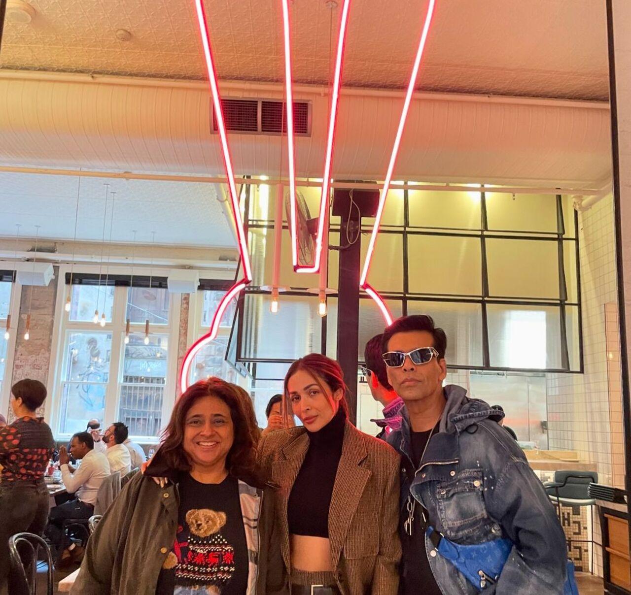 Karan Johar and Malaika Arora pose together at a restaurant in the city