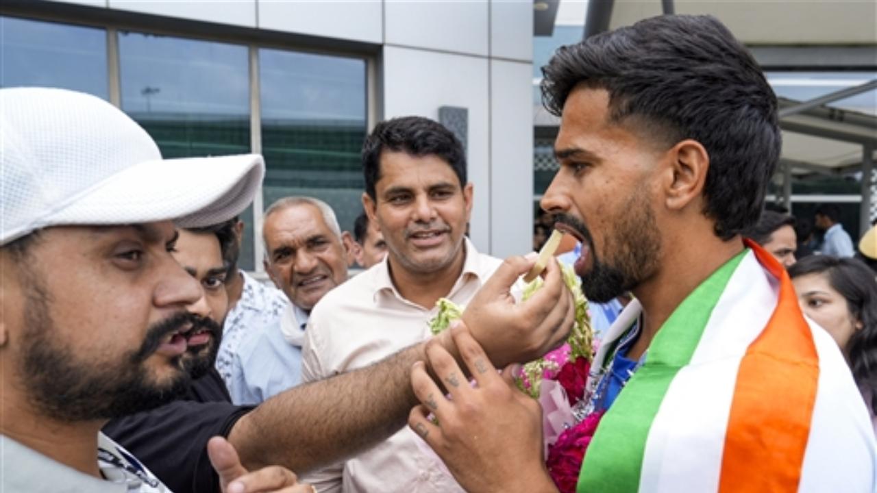 Abhishek Nain was seen being welcomed with sweets. India won consecutive bronze hockey medals for the first time in 52 years, since the 1972 Munich Games