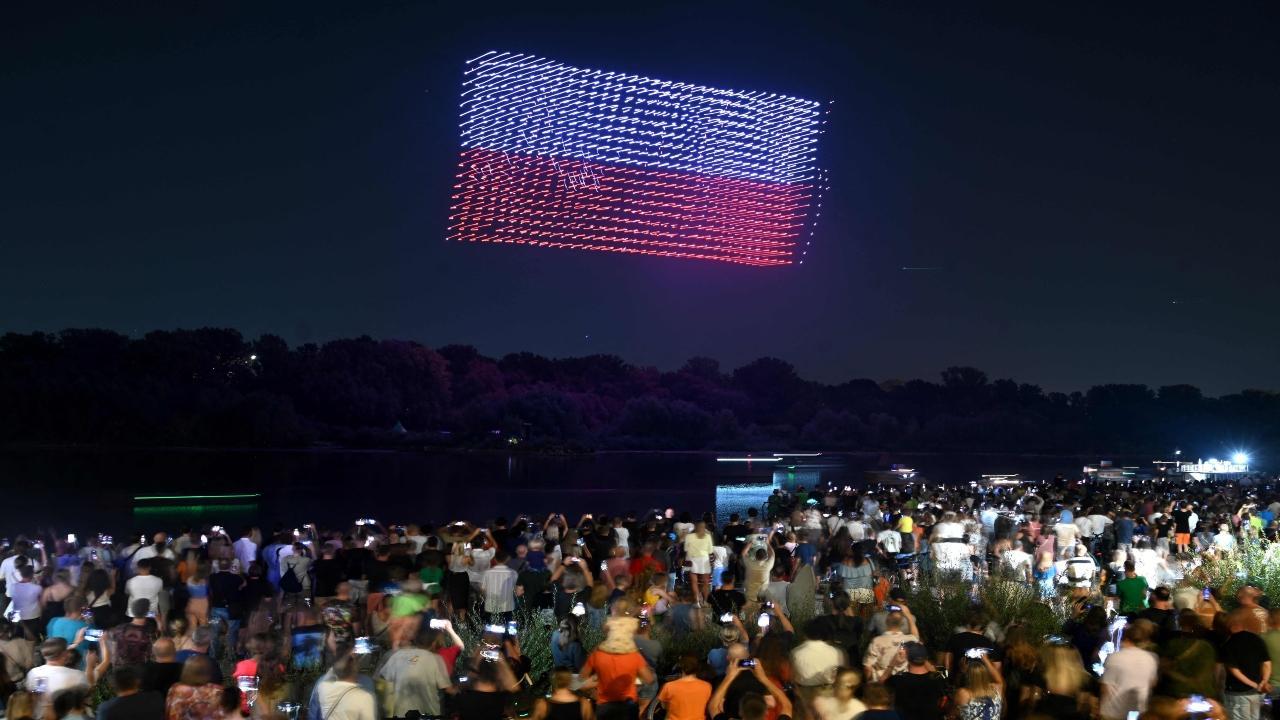 Spectators watch as a swarm of 615 drones forming a pattern depicting Poland's national flag in the night sky during the largest show of its kind in Poland to mark the 80th anniversary of the Warsaw Uprising on Friday. Pic/AFP 