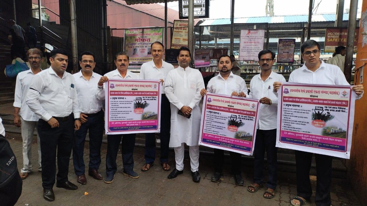Members of the passenger associations hold placards stating their demands.