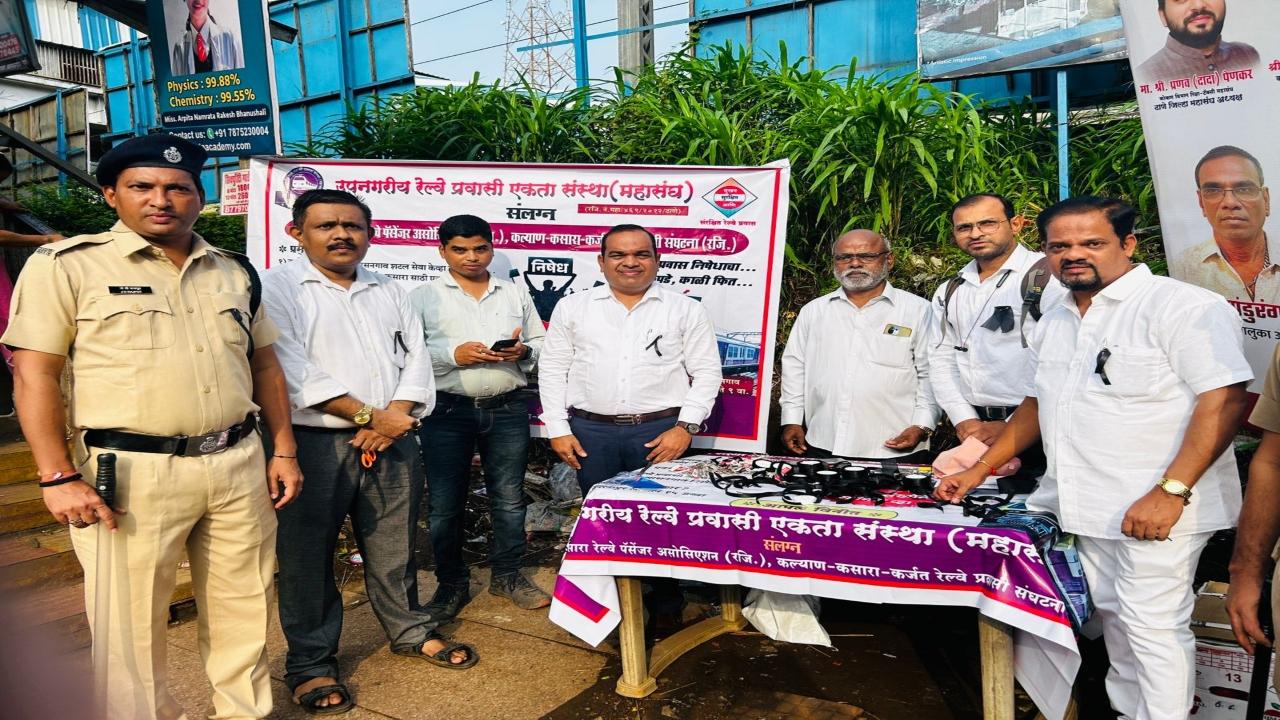 Passenger associations distribute black ribbons to commuters outside Kalyan railway station. 