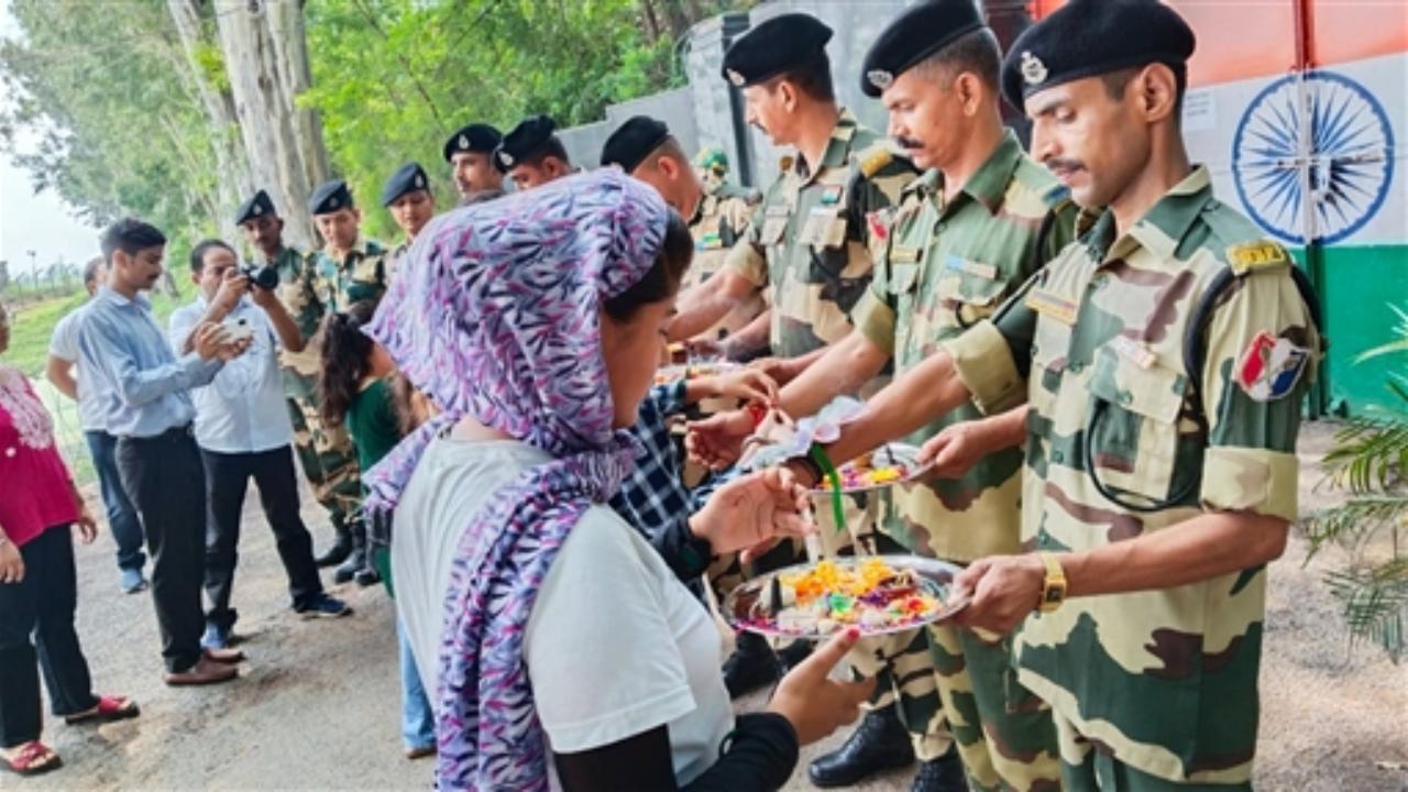 School children tie rakhis to BSF personnel on the occasion of Raksha Bandhan at Arnia in Jammu on Monday (Pic: ANI)