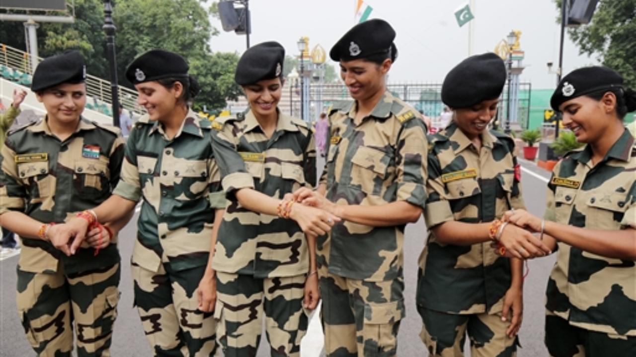 Women Border Security Force (BSF) soldiers tie rakhis to each other on the occasion of Raksha Bandhan festival at the Indo-Pakistan Joint Check Post, Attari-Wagah border, near Amritsar
