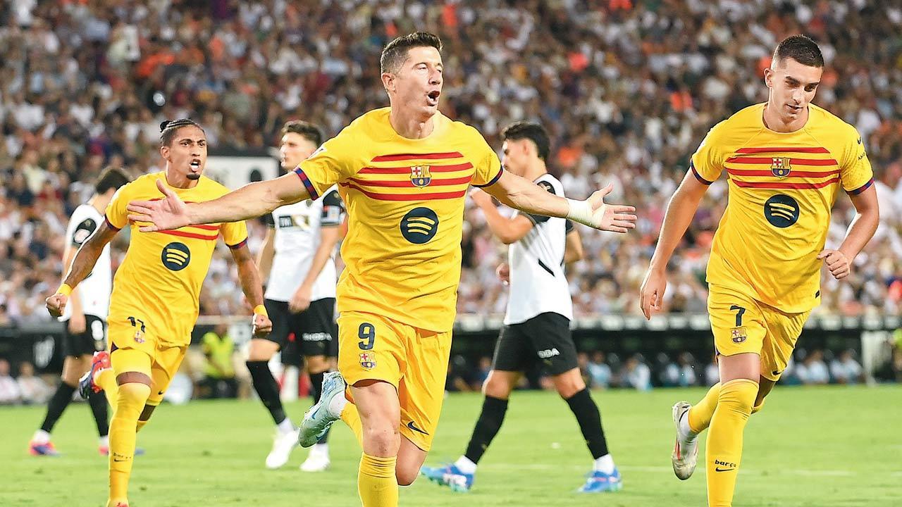 Lewandowski brace hands boss Flick first Barcelona win