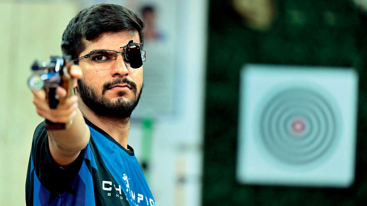 Nishank Jain, a pistol shooter at Champions Shooting Range takes aim with an air pistol during daily practice