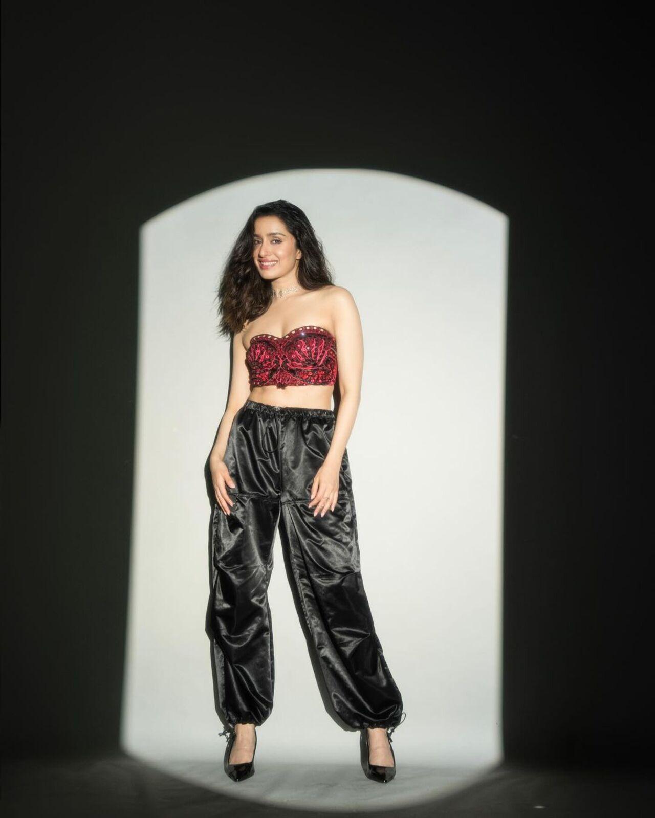 For one of the promotional events, Shraddha stunned in a maroon bralette and baggy black pants