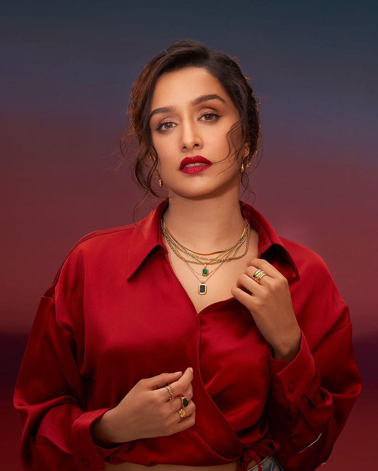 The 'Tu Jhoothi Main Makkaar' actress looked smoking hot in a red silk shirt and bright red lips. She tied her hair up and let some strands of her frame her face 