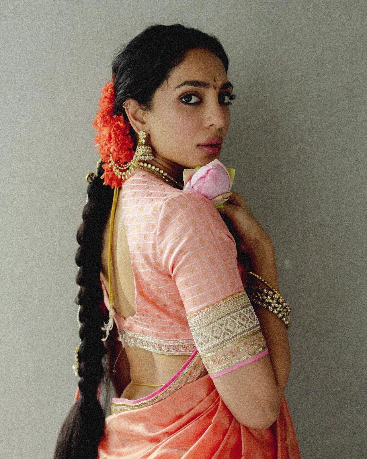 Her hair was braided and adorned with flowers, while she accessorised her look with minimal yet elegant jewellery. 