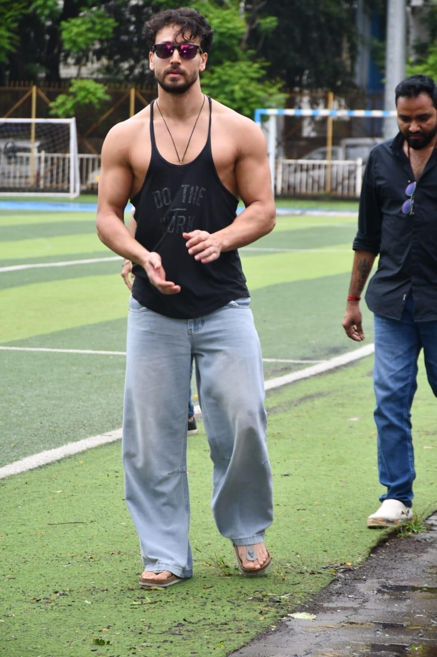 Tiger Shroff was photographed flexing his muscles on the football field today