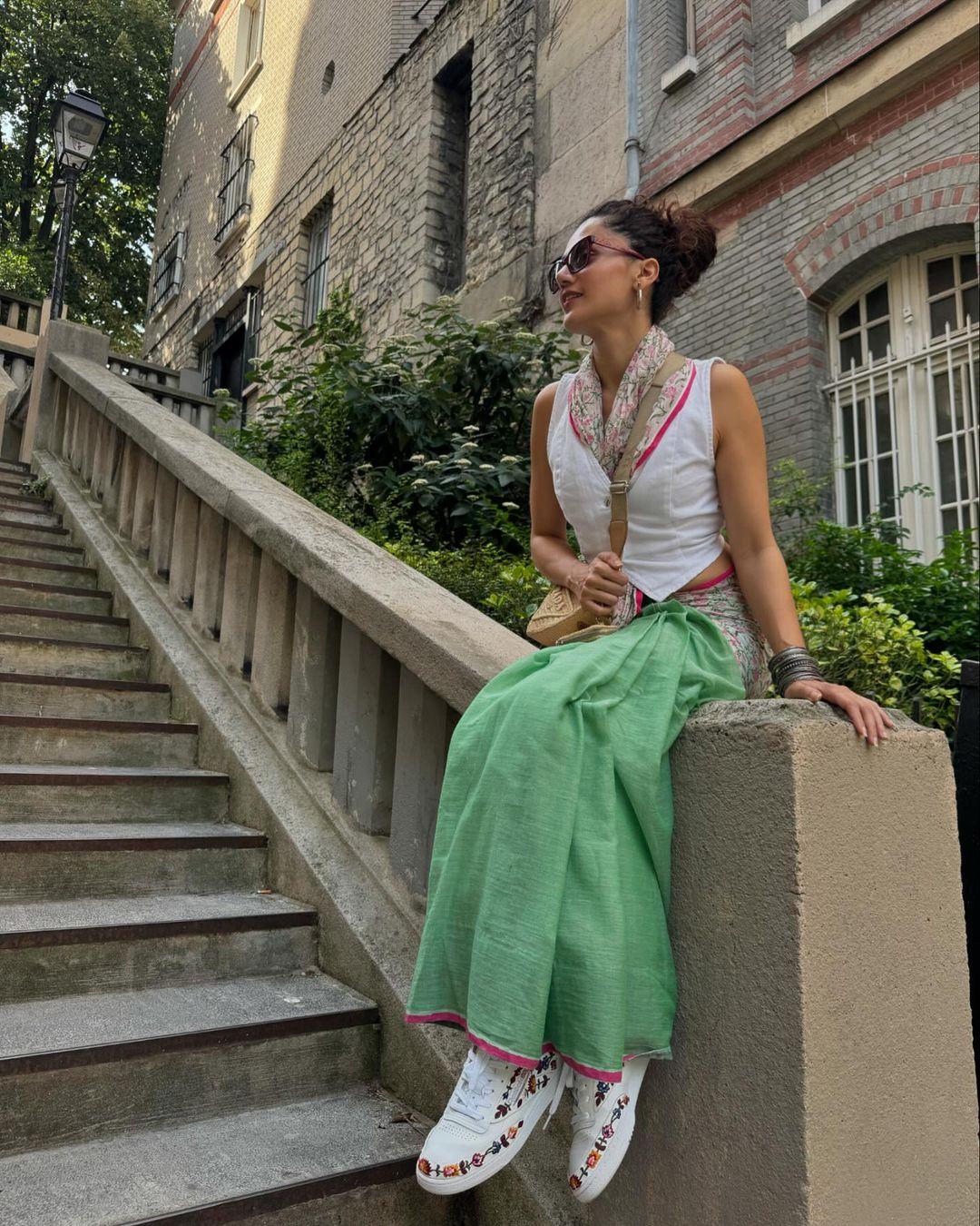 On Day 1, Taapsee wore a lime green saree, which has a printed pallu, with a white waistcoat and sneakers. She wrapped the pallu around her neck like a dupatta, giving an Indo-Western twist to the outfit.