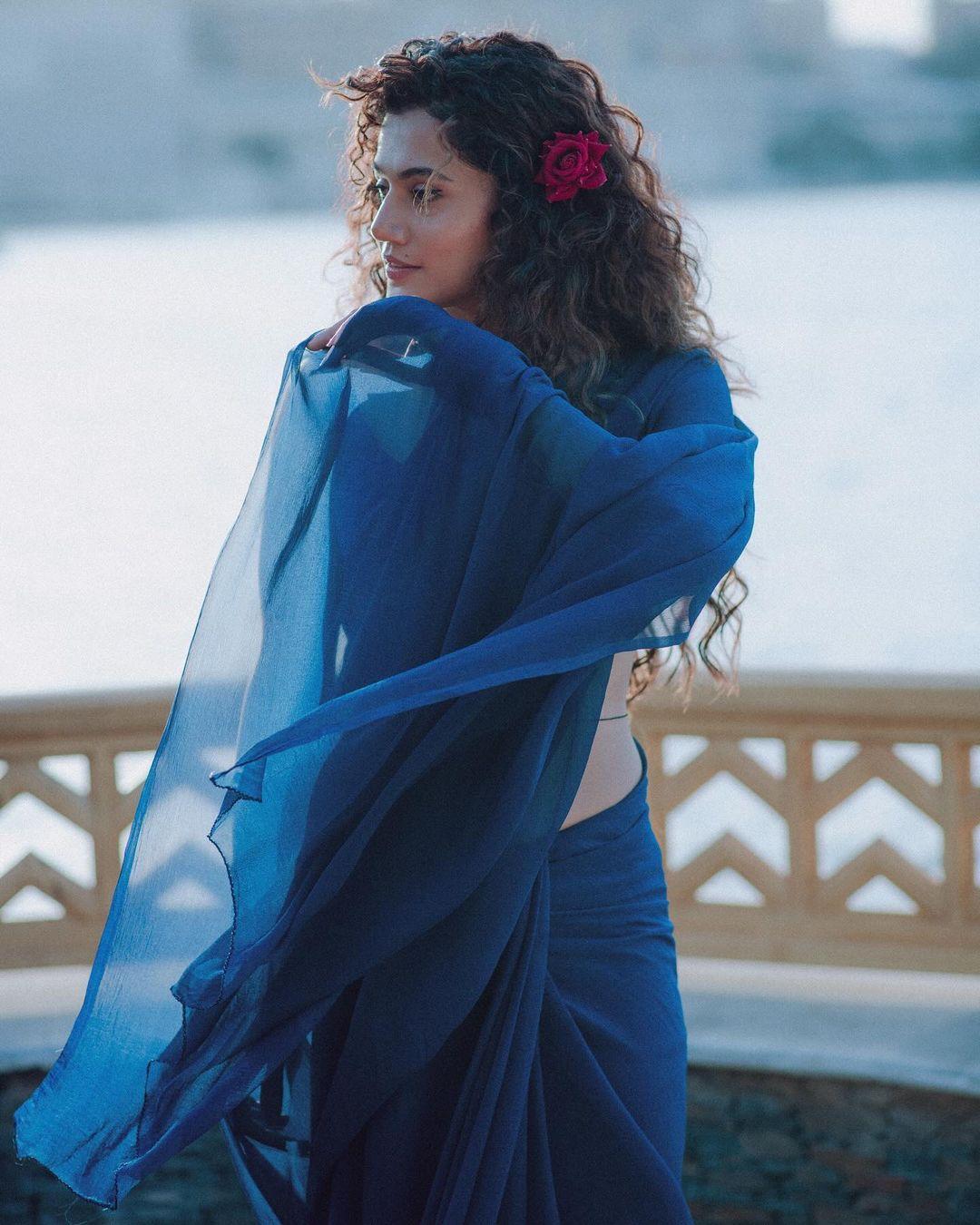 Taapsee Pannu has served looks in plain cotton sarees in a variety of colours. She is seen here in a blue saree posing by the lake