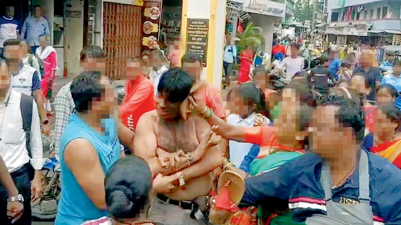 The tuition teacher being dragged to the police station in Virar. Pics/Hanif Patel