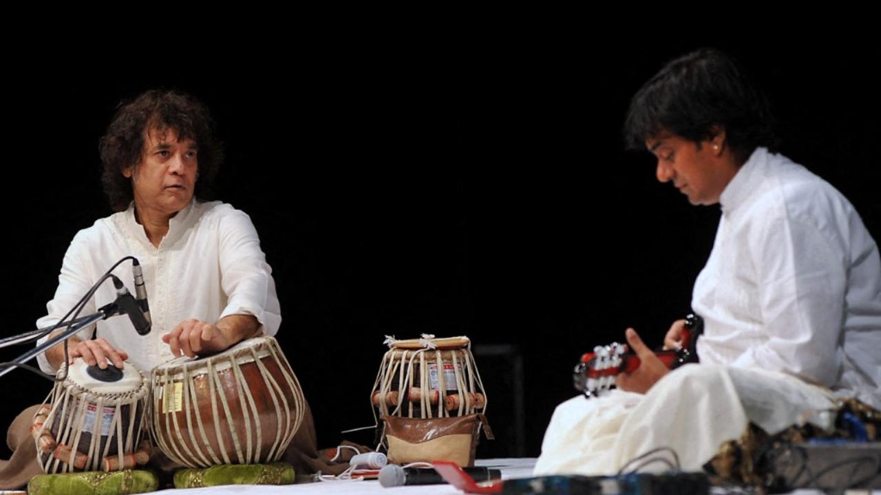 Ustad Zakir Hussain (L) and Ustad Srinivas on mandolin perform a jugalbandi on the eve of 'Homage to Abbaji ', 13th Barsi of late tabla maestro Ustad Alla Rakha in Mumbai on February 3, 2013