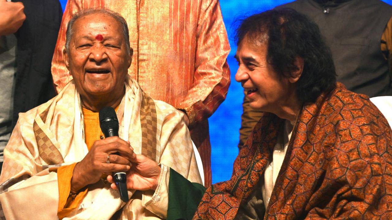 Ustad Zakir Hussain (R) smiles as flautist Pandit Hariprasad Chaurasia laughs after receiving the 1st Padma Vibhushan Ustad Ghulam Mustafa Khan Award in Mumbai on January 17, 2023