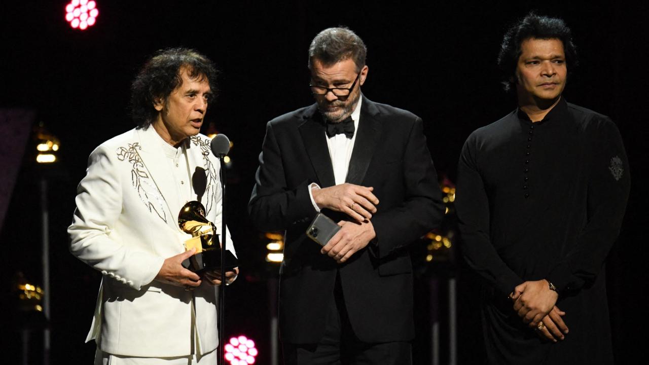 Zakir Hussain, Edgar Meyer and Rakesh Chaurasia accept the 